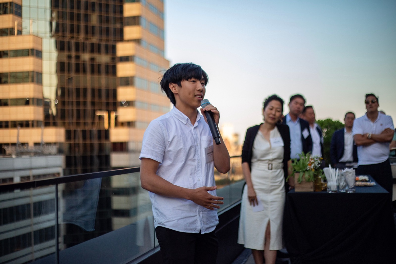 Yang speaking into a microphone at the Apex for Youth Inspiration Awards reception